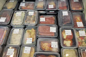 Display case of multiple pre-made meals available at Bella Cucina Foods in West Chester, PA